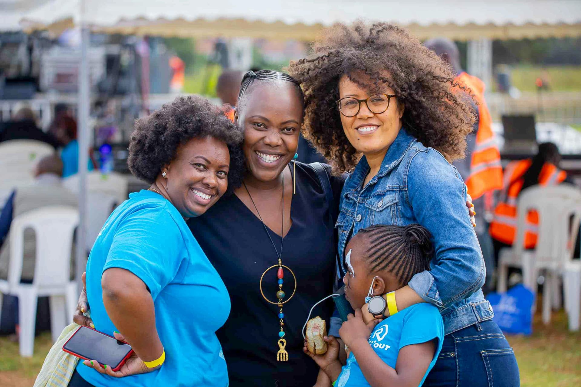 Neighbors and family laughing together at an outdoor community gathering