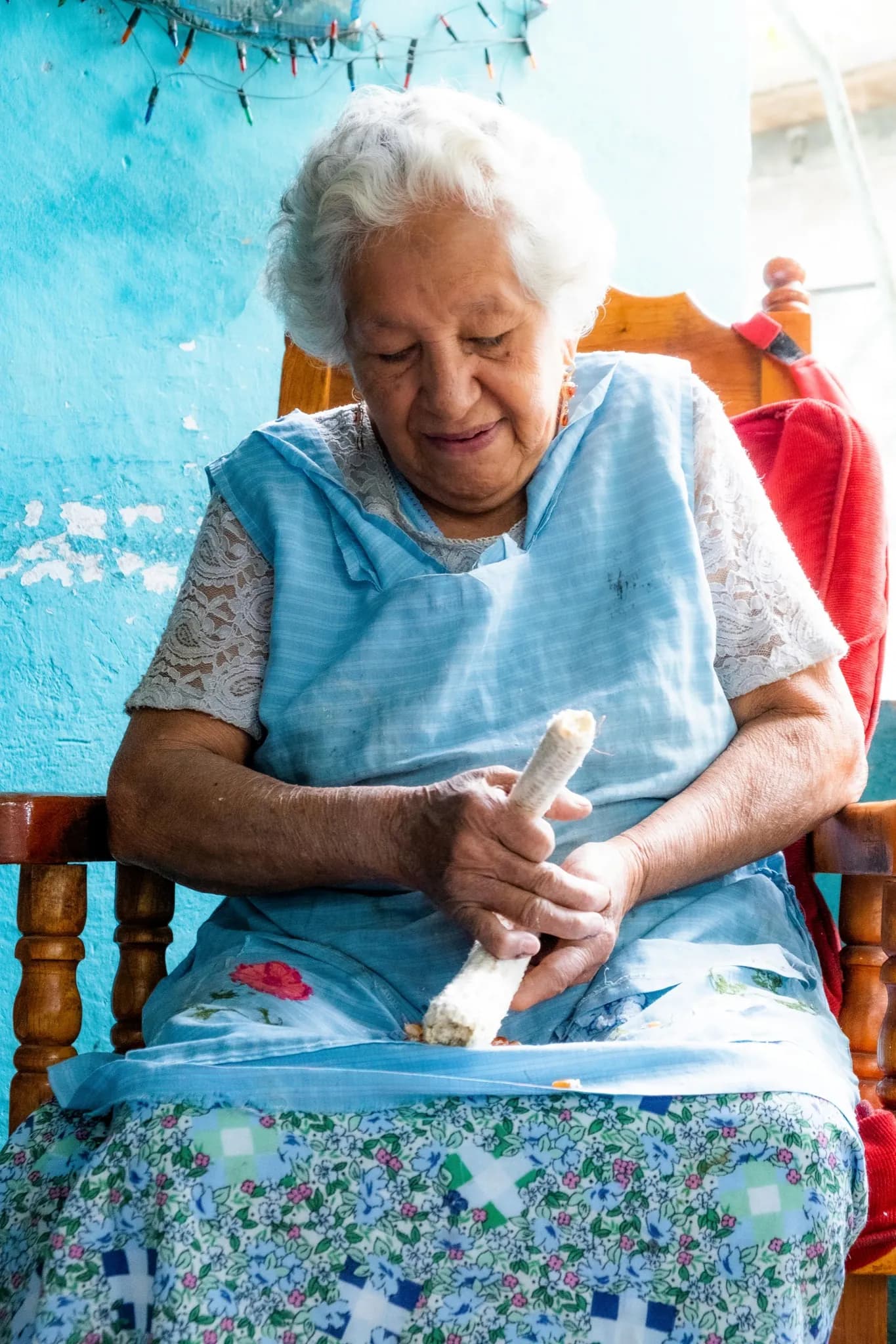 A caregiver reviewing benefit paperwork and bills at a kitchen table in an Indiana home